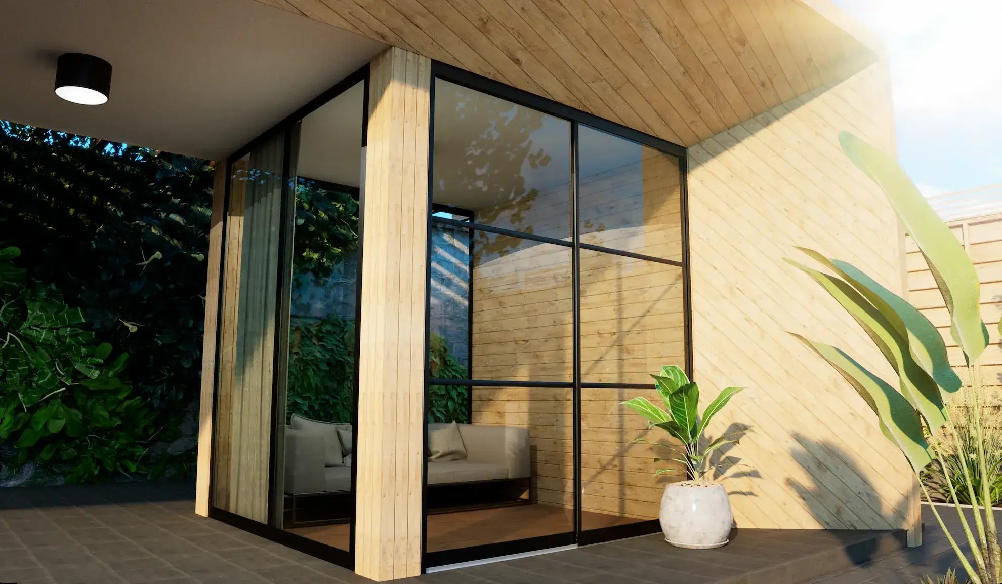 Steellook glazen schuifwand met 2 rails met een bank erbinnen en planten erbuiten ingericht